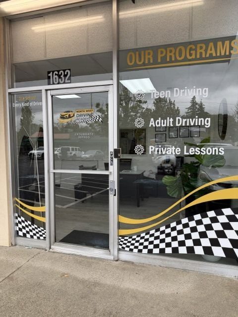 The North West Driving Academy storefront at 1632 SW Dash Point Rd, Federal Way, with programs listed on the window